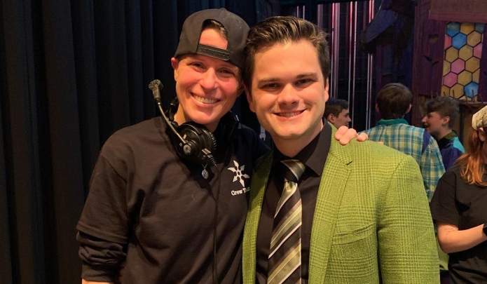 Frederick Miller, in green jacket, poses with a friend back stage.